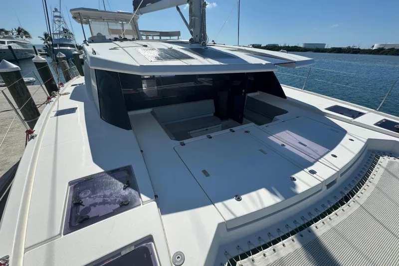 Slide: The Image of 2021 Leopard 45 catamaran docked at marina, showcasing spacious deck and modern design. - 109