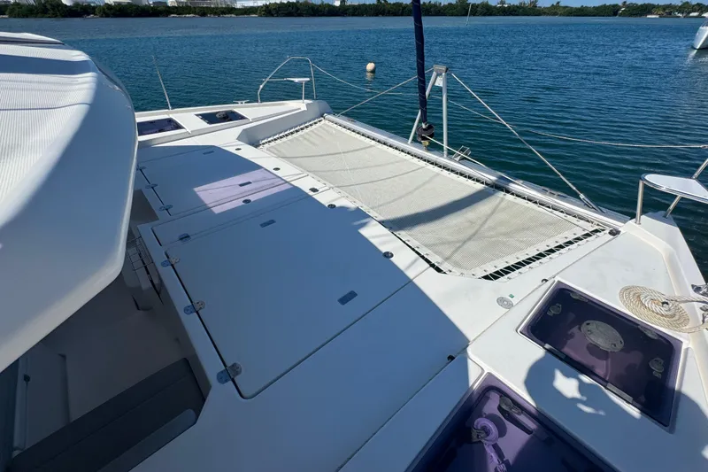 Slide: The Image of Leopard 45 catamaran deck with netting, 2021 model, on calm blue water. - 110