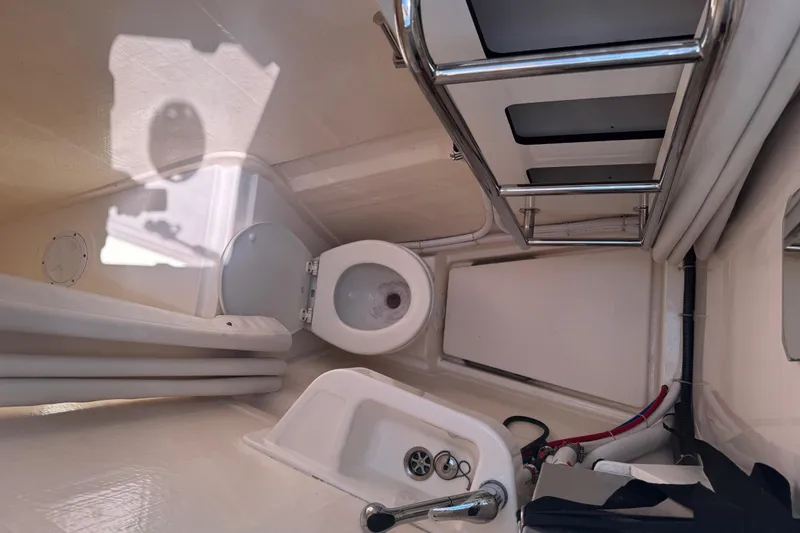 Slide: The Image of Interior of a 2021 Leopard 45 yacht bathroom with toilet and sink. - 112
