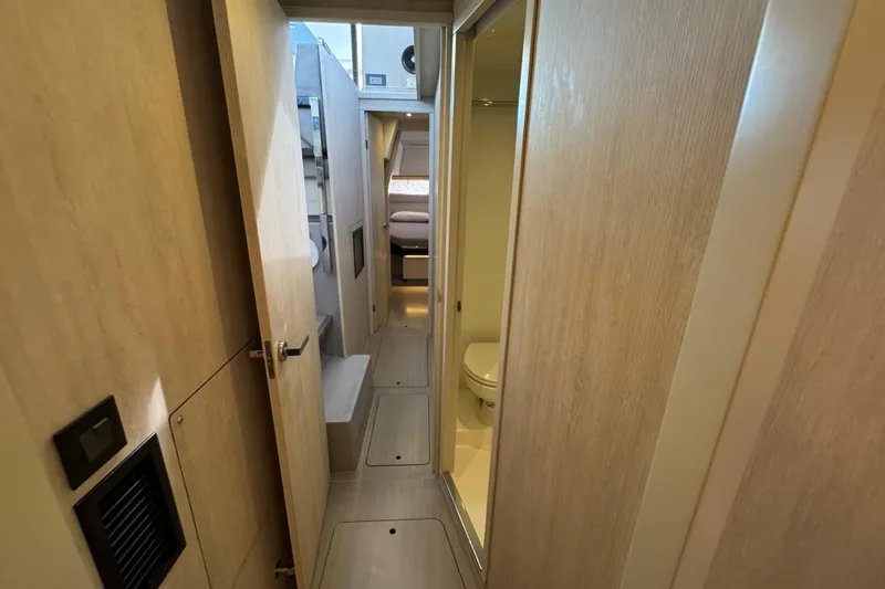 Slide: The Image of Interior hallway of 2021 Leopard 45 yacht, featuring light wood paneling and compact design. - 131