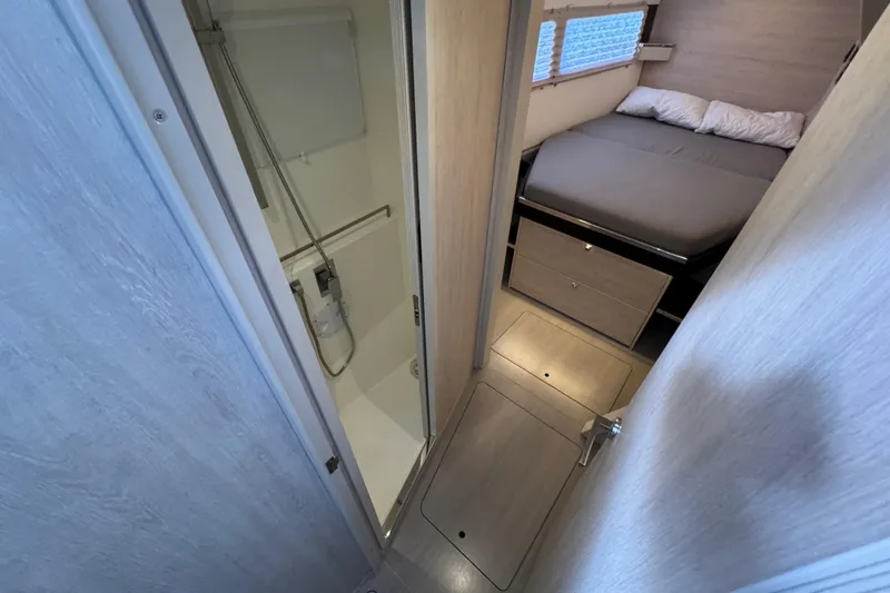 Slide: The Image of Interior of 2021 Leopard 45 yacht showing bedroom and compact bathroom. - 132
