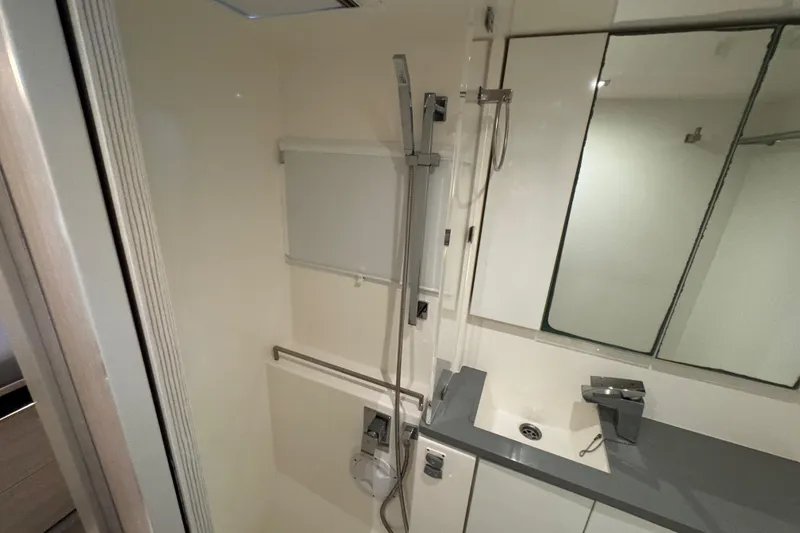 Slide: The Image of Modern bathroom interior in a 2021 Leopard 45 yacht, featuring sleek fixtures and a mirrored cabinet. - 133