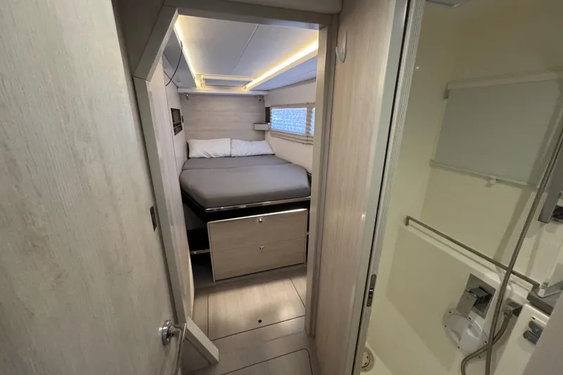 Slide: The Image of Interior of 2021 Leopard 45 yacht cabin with bed and adjacent bathroom. - 139