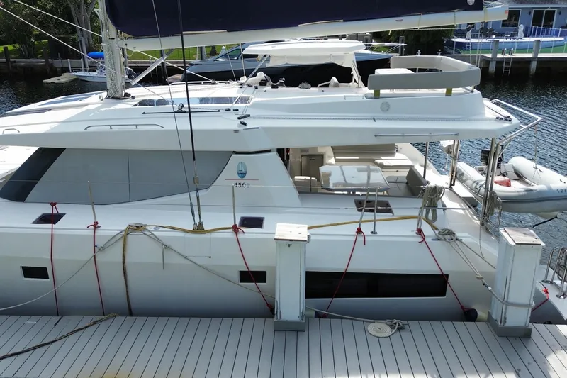 Slide: The Image of 2021 Leopard 45 catamaran docked, featuring spacious deck and modern design. - 14