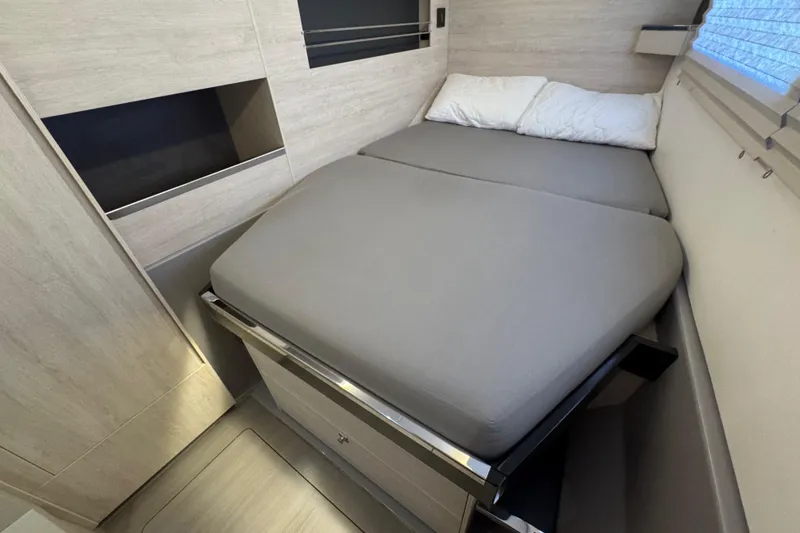 Slide: The Image of Compact bedroom in 2021 Leopard 45 yacht with modern design and cozy bedding. - 140