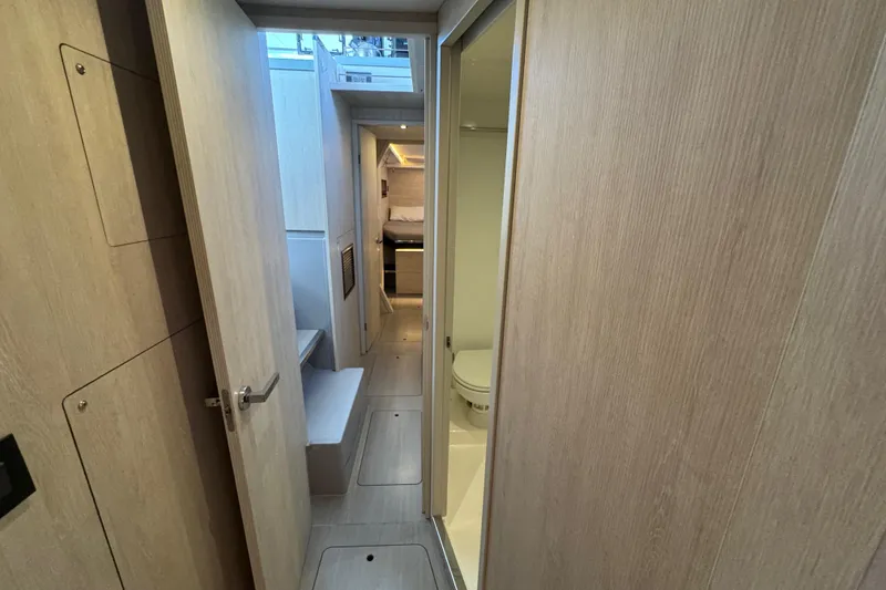 Slide: The Image of Interior of 2021 Leopard 45 yacht showing hallway, bathroom, and cabin. - 144