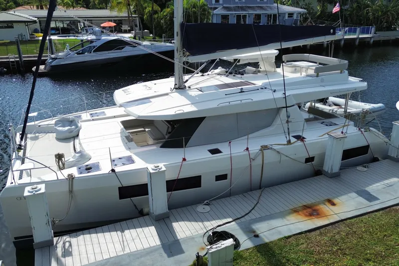 Slide: The Image of 2021 Leopard 45 catamaran docked at a marina, featuring sleek design and spacious deck. - 15