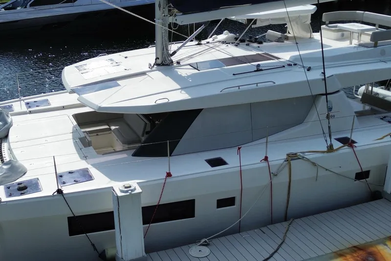 Slide: The Image of Modern 2021 Leopard 45 catamaran docked at marina, showcasing sleek design and spacious deck. - 16