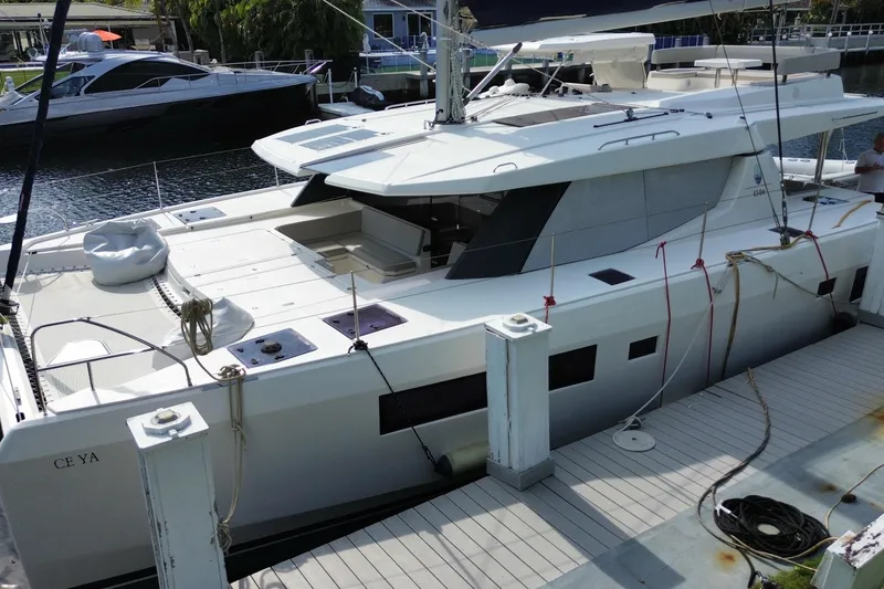 Slide: The Image of 2021 Leopard 45 catamaran docked at marina, showcasing sleek design and spacious deck. - 18