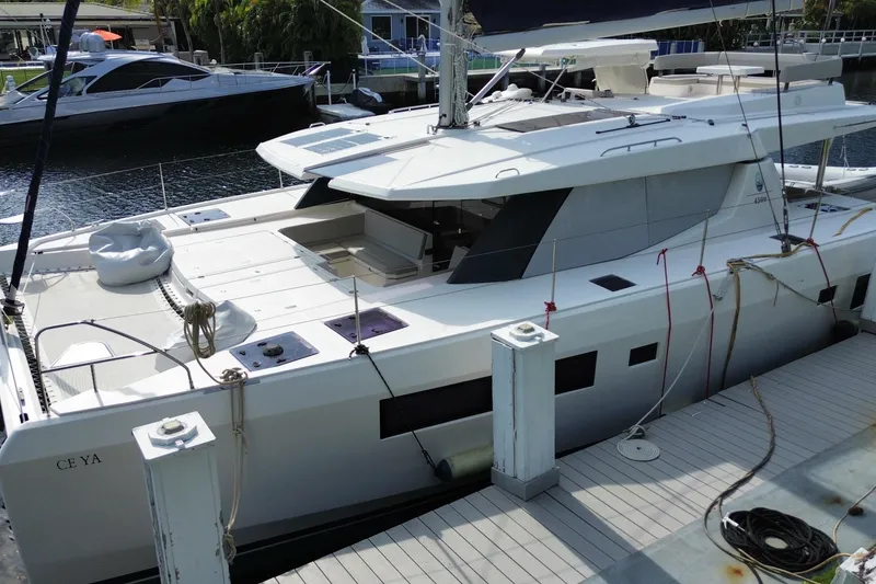 Slide: The Image of 2021 Leopard 45 catamaran docked, featuring spacious deck and modern design. - 19