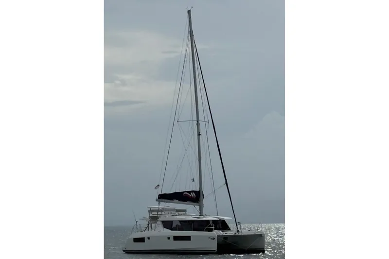Slide: The Image of 2021 Leopard 45 catamaran sailing on calm waters under a cloudy sky. - 23