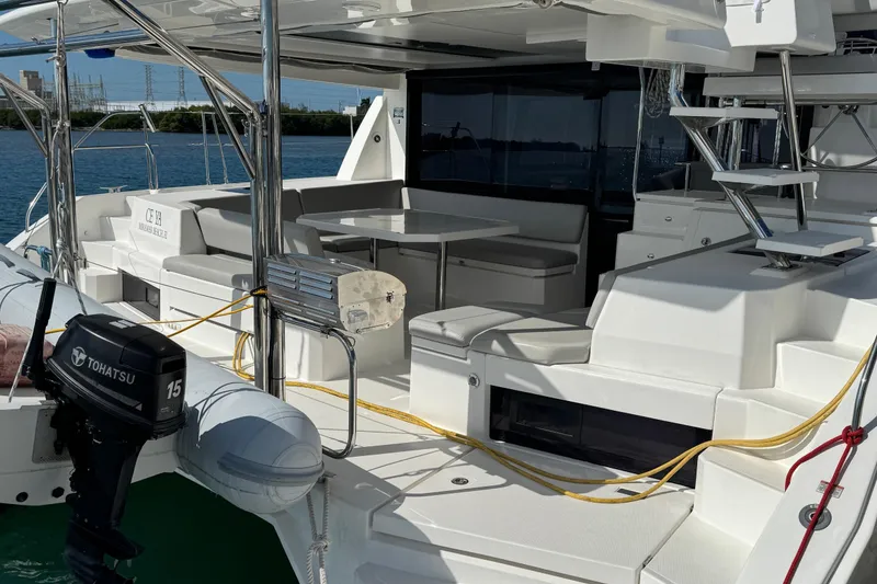 Slide: The Image of 2021 Leopard 45 catamaran with outdoor seating and Tohatsu outboard motor. - 29