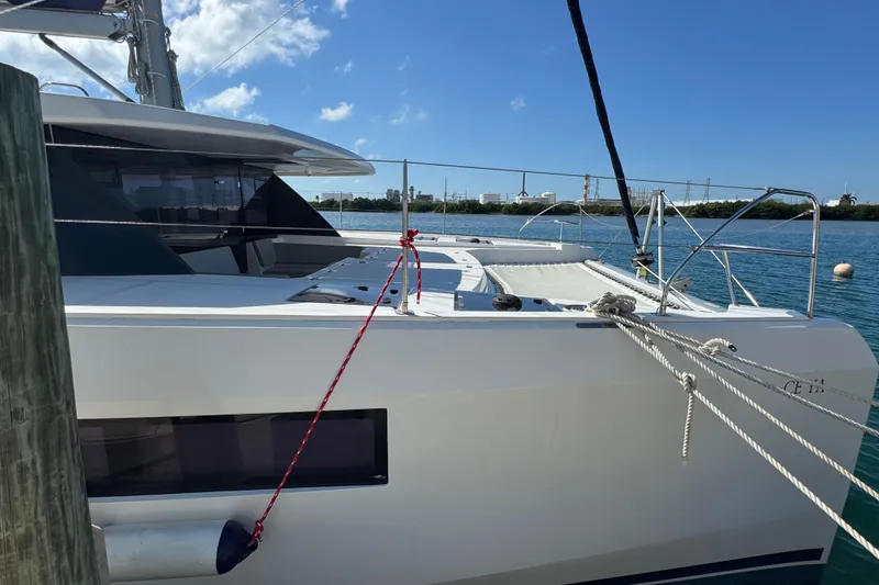 Slide: The Image of 2021 Leopard 45 catamaran docked on a sunny day with clear blue skies. - 31