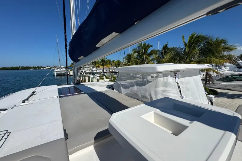 Slide: The Image of 2021 Leopard 45 catamaran docked at marina with palm trees and clear blue sky. - 34