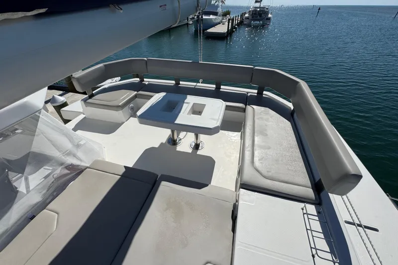 Slide: The Image of Leopard 45 yacht deck with seating and table, overlooking serene marina waters. - 35