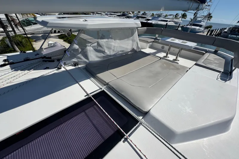 Slide: The Image of 2021 Leopard 45 yacht deck with seating and table, docked at marina. - 37