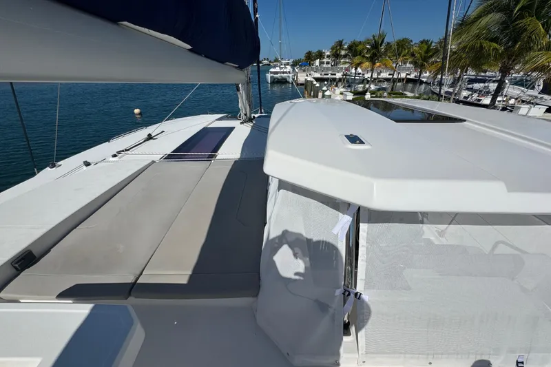 Slide: The Image of 2021 Leopard 45 catamaran docked at marina, featuring spacious deck and modern design. - 38