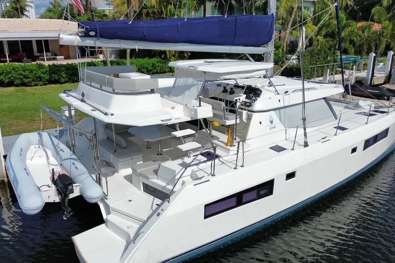 Slide: The Image of 2021 Leopard 45 catamaran docked, featuring spacious deck and modern design. - 4
