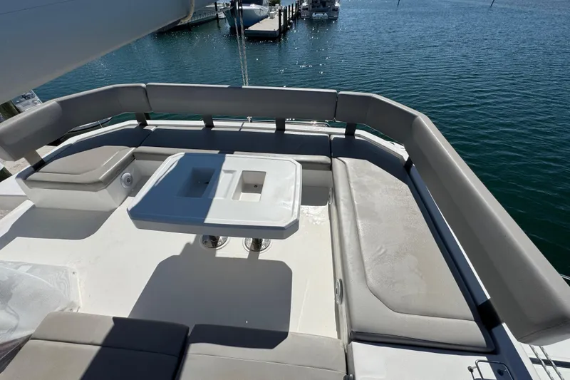 Slide: The Image of Leopard 45 catamaran 2021 model, featuring spacious outdoor seating and table, docked by the water. - 50