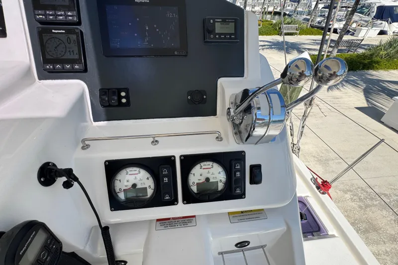 Slide: The Image of Control panel of a 2021 Leopard 45 yacht with navigation instruments and throttle levers. - 57