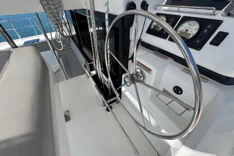 Slide: The Image of Steering wheel and controls of a 2021 Leopard 45 catamaran yacht. - 59
