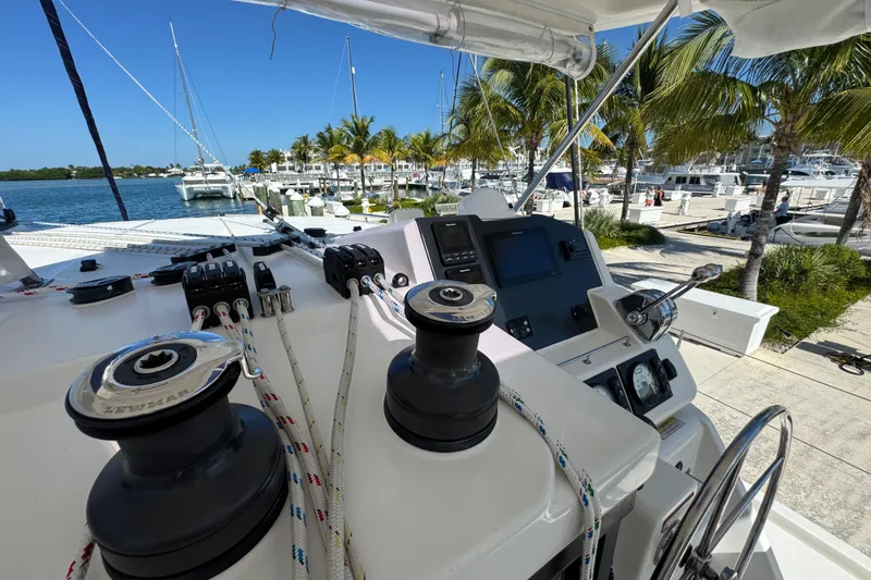 Slide: The Image of Helm of 2021 Leopard 45 catamaran docked at marina with palm trees. - 62