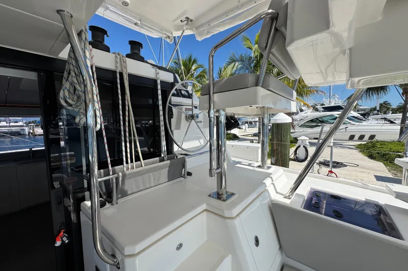 Slide: The Image of Leopard 45 yacht helm station with ropes and steering wheel, docked at marina. - 63