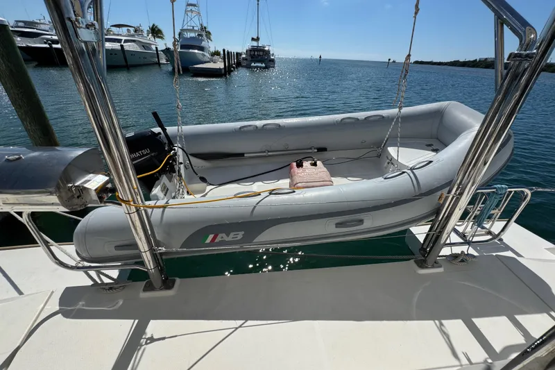 Slide: The Image of Inflatable boat on Leopard 45 catamaran, docked at marina, sunny day, 2021 model. - 64