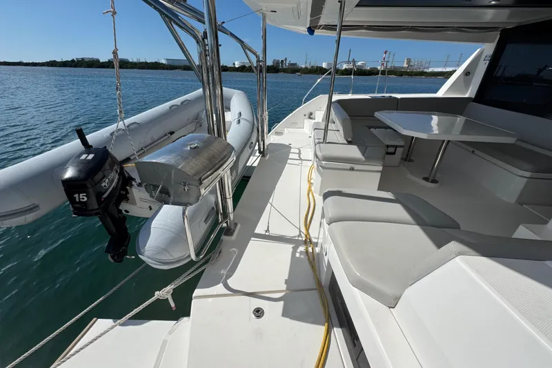 Slide: The Image of Leopard 45 yacht deck with seating, table, and attached dinghy, 2021 model. - 65