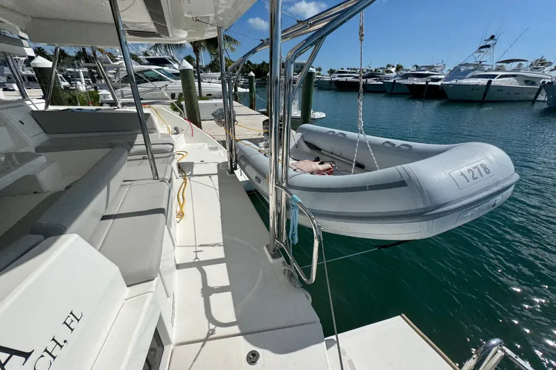 Slide: The Image of Leopard 45 catamaran with dinghy, docked at marina, sunny day, 2021 model. - 73