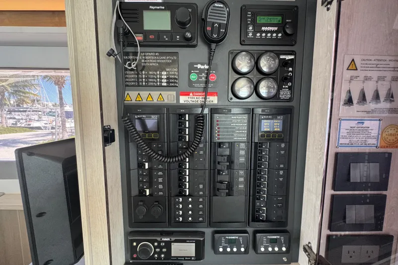 Slide: The Image of Electrical control panel inside a 2021 Leopard 45 yacht, featuring various switches and gauges. - 88