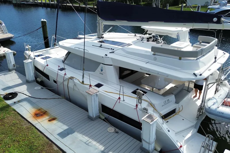 Slide: The Image of 2021 Leopard 45 catamaran docked at marina, featuring spacious deck and modern design. - 9