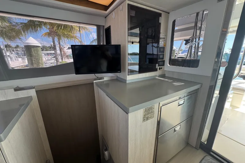 Slide: The Image of Interior of a 2021 Leopard 45 yacht with modern kitchen and TV. - 91