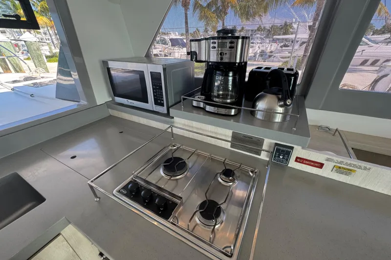 Slide: The Image of Modern kitchen in 2021 Leopard 45 yacht with stove, microwave, and coffee maker. - 93