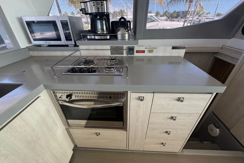 Slide: The Image of Modern kitchen in a 2021 Leopard 45 yacht with stove, oven, and microwave. - 94