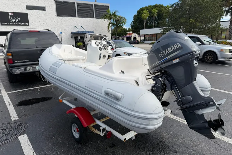 Slide: The Image of Inflatable boat with Yamaha outboard motor in parking lot, Caribe 12 model, 2011. - 5