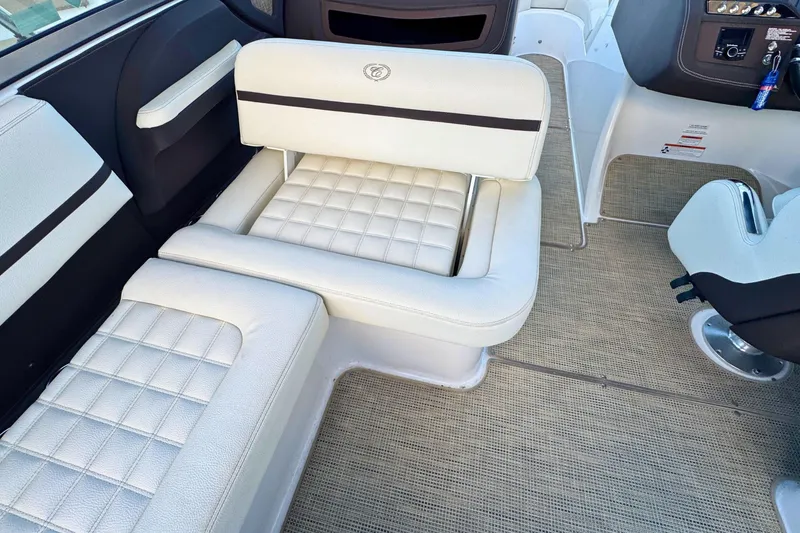 Slide: The Image of 2019 Cobalt R3 boat interior with white cushioned seating and modern dashboard. - 12