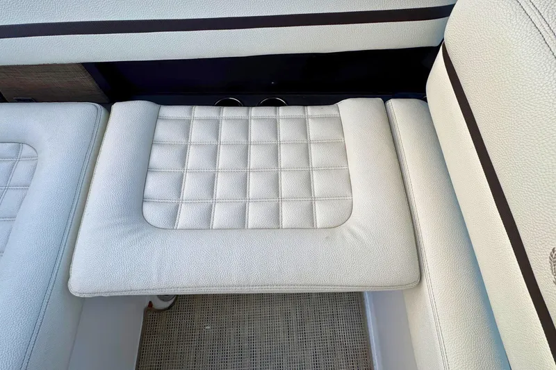 Slide: The Image of 2019 Cobalt R3 boat interior with white cushioned seating and textured design. - 14