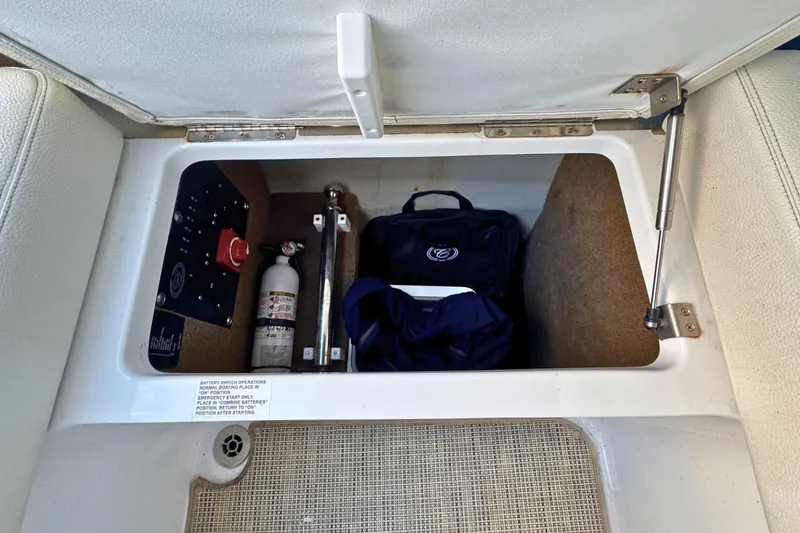 Slide: The Image of Storage compartment in a 2019 Cobalt R3 boat with safety equipment. - 15