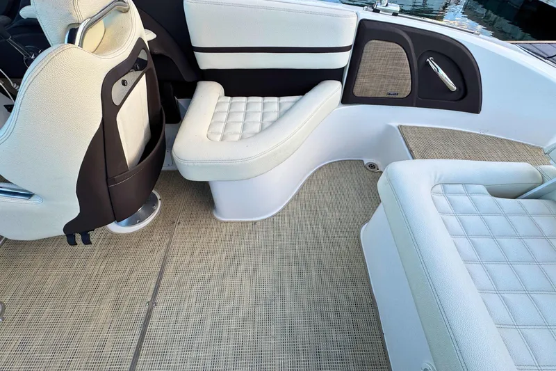 Slide: The Image of 2019 Cobalt R3 boat interior with white cushioned seating and beige flooring. - 16