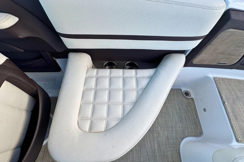 Slide: The Image of 2019 Cobalt R3 boat interior with white cushioned seating and cup holders. - 17