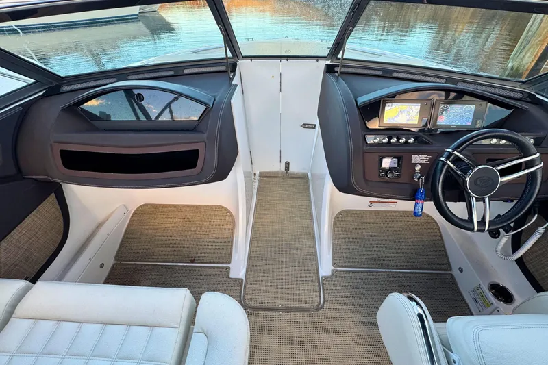 Slide: The Image of 2019 Cobalt R3 boat interior with modern dashboard and steering wheel, overlooking water. - 19