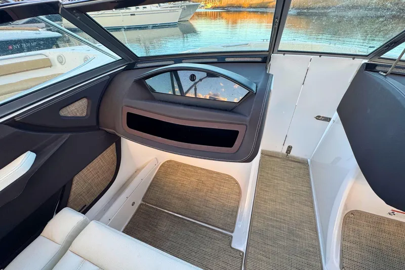 Slide: The Image of Interior of a 2019 Cobalt R3 boat, featuring seating and window view. - 21