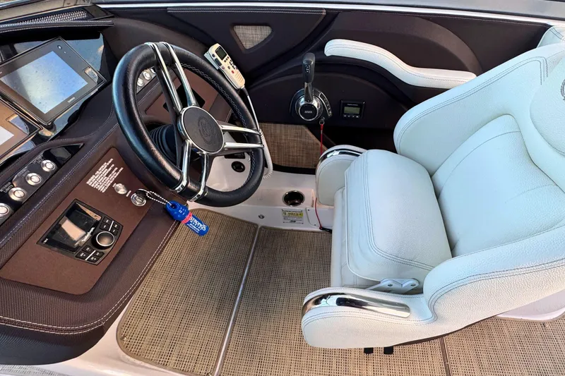 Slide: The Image of 2019 Cobalt R3 boat cockpit with steering wheel and white captain's chair. - 25