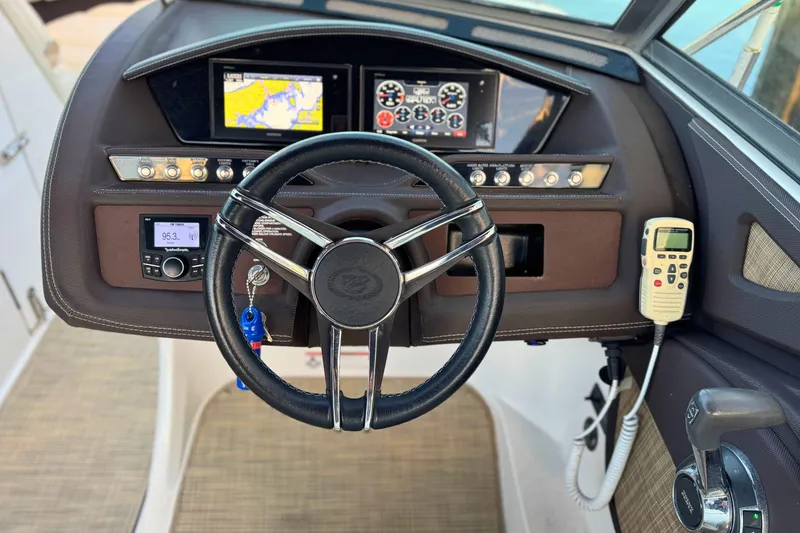 Slide: The Image of 2019 Cobalt R3 boat dashboard with steering wheel, navigation screens, and control panel. - 26