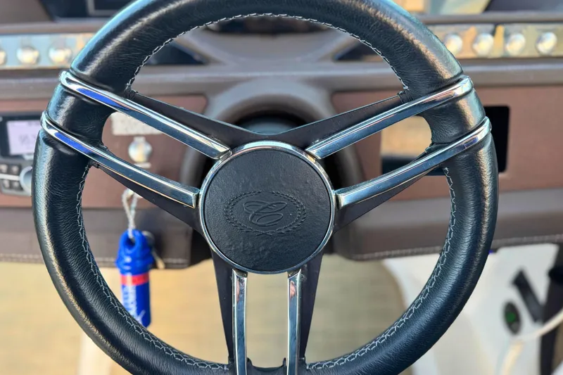 Slide: The Image of Steering wheel of a 2019 Cobalt R3 boat, featuring sleek design and leather finish. - 28