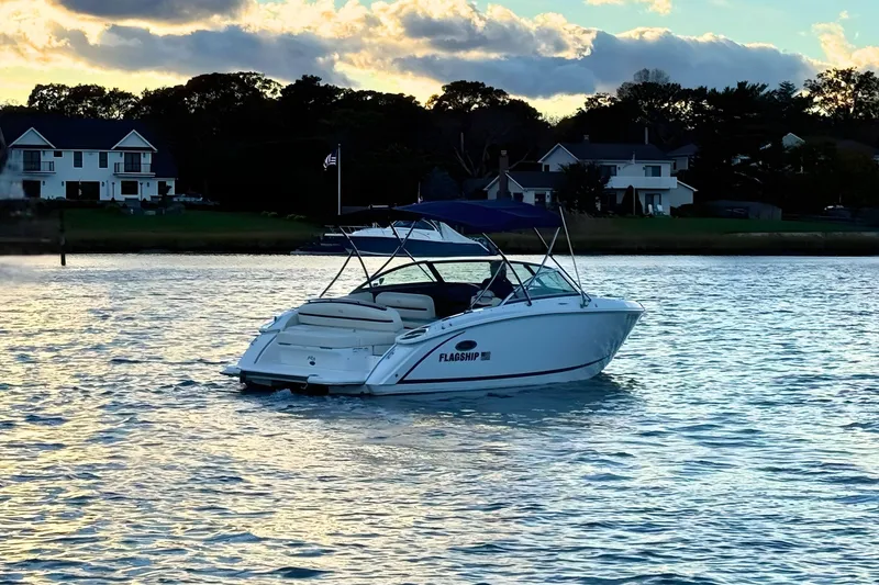 Slide: The Image of 2019 Cobalt R3 boat on calm water near shoreline houses at sunset. - 3