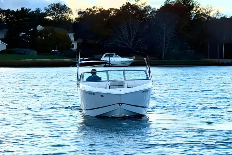 Slide: The Image of 2019 Cobalt R3 boat cruising on a serene lake with trees in the background. - 6