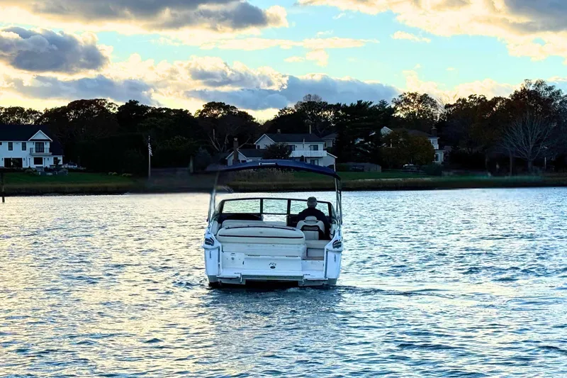 Slide: The Image of 2019 Cobalt R3 boat cruising on a serene lake at sunset. - 7