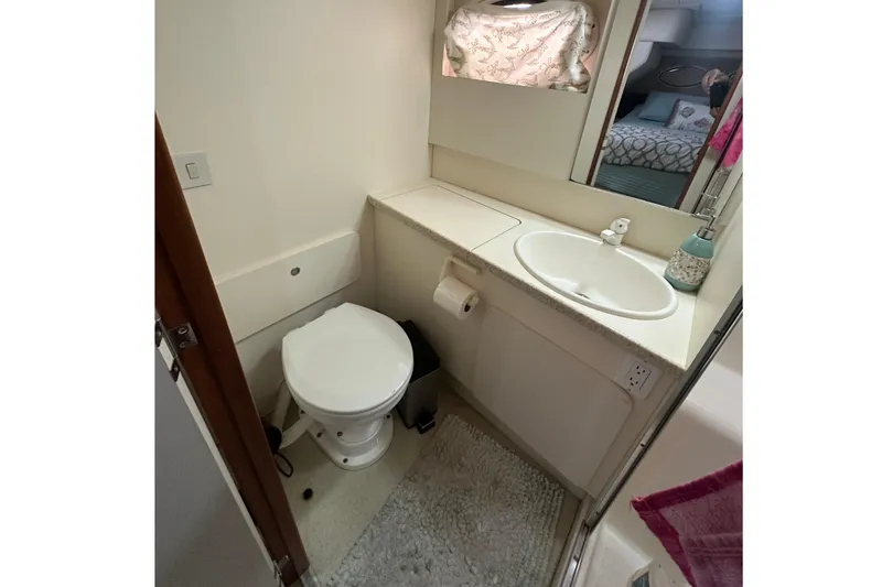 Slide: The Image of 1998 Silverton 372 Motor Yacht interior with cozy bedroom and bathroom. - 14